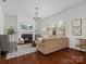 This living room showcases a fireplace, a large sofa, natural light and neutral paint at 1016 Hickory Pine Rd, Waxhaw, NC 28173