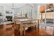 Open floorplan living area with wood floors, a fireplace, ample natural light, and stylish furnishings at 1016 Hickory Pine Rd, Waxhaw, NC 28173