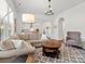 Inviting living room with plush sectional sofa, stylish rug, and arched entryway to the kitchen at 1016 Hickory Pine Rd, Waxhaw, NC 28173