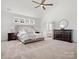 Lovely main bedroom featuring neutral tones, large windows, and a view into the ensuite at 1016 Hickory Pine Rd, Waxhaw, NC 28173