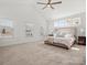 Large main bedroom with neutral carpet, high ceilings, and lots of windows for natural light at 1016 Hickory Pine Rd, Waxhaw, NC 28173