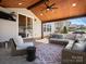 Covered outdoor living area featuring comfortable seating and stylish decor at 1016 Hickory Pine Rd, Waxhaw, NC 28173