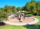 A colorful playground surrounded by mature trees, providing a safe and fun recreation area at 1016 Hickory Pine Rd, Waxhaw, NC 28173