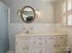 Bathroom featuring white vanity with a rounded mirror and vanity lights at 1026 Norwich Rd, Charlotte, NC 28227