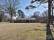 Charming brick ranch home with a well-manicured lawn and traditional shutters on the front windows at 1026 Norwich Rd, Charlotte, NC 28227