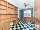 Office with custom built-in shelving and storage, featuring black and white tile flooring at 1026 Norwich Rd, Charlotte, NC 28227