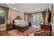 Spacious bedroom with hardwood floors, a chandelier, and french doors leading to a balcony at 105 Grey Lady Ct, Mooresville, NC 28117