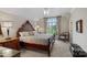 Bedroom with a large window, plush bedding, and a dark wood dresser at 105 Grey Lady Ct, Mooresville, NC 28117