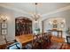 Elegant dining room featuring a chandelier, detailed molding, and beautiful hardwood floors at 105 Grey Lady Ct, Mooresville, NC 28117