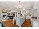 The kitchen includes a central island with barstool seating and seamlessly connects to a living area at 105 Grey Lady Ct, Mooresville, NC 28117