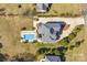 Aerial view showcases a sparkling pool, patio with pergola, and manicured landscaping at 109 Dabbling Duck Cir, Mooresville, NC 28117