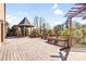 Expansive back deck featuring a gazebo, pergola, wood benches, and lush landscaping at 109 Dabbling Duck Cir, Mooresville, NC 28117