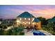 Outdoor living space featuring a pool, multiple decks and patios ideal for entertaining under a colorful evening sky at 109 Dabbling Duck Cir, Mooresville, NC 28117