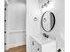 Bright bathroom with white vanity, black accents, modern mirror, and updated fixtures at 109 Dabbling Duck Cir, Mooresville, NC 28117
