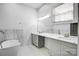 Bright bathroom featuring dual sinks, marble accents, and a soaking tub at 109 Dabbling Duck Cir, Mooresville, NC 28117