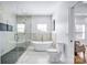 Bright bathroom featuring a soaking tub, walk-in shower, and tiled floors at 109 Dabbling Duck Cir, Mooresville, NC 28117