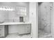 Bathroom features dual sinks, marble countertops, and frameless glass shower at 109 Dabbling Duck Cir, Mooresville, NC 28117