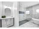 Bathroom featuring a marble shower, soaking tub, dual sinks, and modern lighting at 109 Dabbling Duck Cir, Mooresville, NC 28117