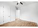 A well-lit bedroom with beautiful hardwood floors, a ceiling fan, and neutral walls at 109 Dabbling Duck Cir, Mooresville, NC 28117