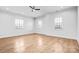 Spacious bedroom features hardwood floors, ceiling fan, neutral walls, and multiple windows at 109 Dabbling Duck Cir, Mooresville, NC 28117