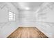 Walk-in closet with custom shelving and hardwood floors at 109 Dabbling Duck Cir, Mooresville, NC 28117