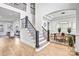Grand foyer with hardwood floors, staircase with iron railings, and views into the living and dining areas at 109 Dabbling Duck Cir, Mooresville, NC 28117