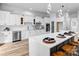 Bright kitchen features white cabinetry, stainless steel appliances, tile backsplash, and quartz countertops at 109 Dabbling Duck Cir, Mooresville, NC 28117