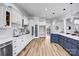 Open kitchen with a large island, stainless steel appliances, and hardwood floors overlooking living area at 109 Dabbling Duck Cir, Mooresville, NC 28117