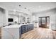 Open kitchen with a large island, stainless steel appliances, and hardwood floors overlooking living area at 109 Dabbling Duck Cir, Mooresville, NC 28117