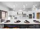 Beautiful kitchen with white cabinets, stainless appliances, accent backsplash, and pendant lighting at 109 Dabbling Duck Cir, Mooresville, NC 28117