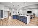 Spacious open-concept kitchen with a large island, stainless steel appliances, and hardwood floors at 109 Dabbling Duck Cir, Mooresville, NC 28117