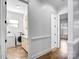 Well-lit laundry room with modern washer, dryer, utility sink, and convenient storage at 109 Dabbling Duck Cir, Mooresville, NC 28117