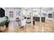 Open-concept living room and kitchen featuring hardwood floors, white cabinetry, and modern appliances at 109 Dabbling Duck Cir, Mooresville, NC 28117