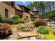 Backyard features a custom water feature, lush landscaping, and a brick exterior at 1220 Broadside Rd, York, SC 29745