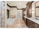Luxurious bathroom with a soaking tub, dual vanities, and travertine tile at 1220 Broadside Rd, York, SC 29745