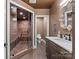 Luxurious bathroom features a glass enclosed shower with a built-in seat, elegant sink and flooring at 1220 Broadside Rd, York, SC 29745