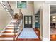 Elegant foyer with hardwood floors, a staircase with wrought iron railings, and a decorative entry door at 1220 Broadside Rd, York, SC 29745