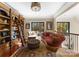 Cozy sitting area featuring custom built-in bookcase with a ladder and a comfortable chaise lounge at 1220 Broadside Rd, York, SC 29745