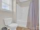 Bright bathroom with a shower/tub combo, white toilet, and neutral walls at 12852 Mustang Dr, Midland, NC 28107