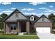 Charming brick home with a covered porch, gray gable accents, and a two-car garage at 13122 Macon Hall Dr, Mint Hill, NC 28227