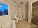 Bathroom with a shower and tub combo. Features tile floors and trim at 1516 Plantation Trl, Gastonia, NC 28056