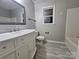 Bathroom featuring a large mirror, vanity, and gray tile at 1516 Plantation Trl, Gastonia, NC 28056