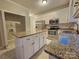 Well-equipped kitchen with an island, white cabinets, stainless steel appliances, and granite countertops at 1516 Plantation Trl, Gastonia, NC 28056