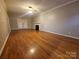 Spacious living room featuring hardwood floors, neutral walls, and a decorative fireplace at 1516 Plantation Trl, Gastonia, NC 28056
