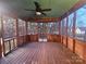 Spacious screened porch with ceiling fan overlooking the backyard. Perfect for relaxing or entertaining guests at 1516 Plantation Trl, Gastonia, NC 28056