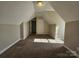 Neutral attic room featuring neutral carpet and paint and doors, ready to repurpose for a variety of uses at 159 S Gibbs Rd, Mooresville, NC 28117