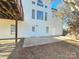 Exterior view of the back of the home with a concrete patio and a few trees at 159 S Gibbs Rd, Mooresville, NC 28117