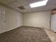 Basement area with neutral walls, carpet, and tile floor, ready for a variety of uses at 159 S Gibbs Rd, Mooresville, NC 28117