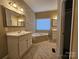 Neutral bathroom featuring tile floors, a soaking tub, and double vanity at 159 S Gibbs Rd, Mooresville, NC 28117