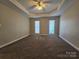Spacious bedroom featuring neutral walls, carpet floors, and two windows at 159 S Gibbs Rd, Mooresville, NC 28117